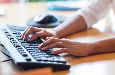 Hands typing on keyboard